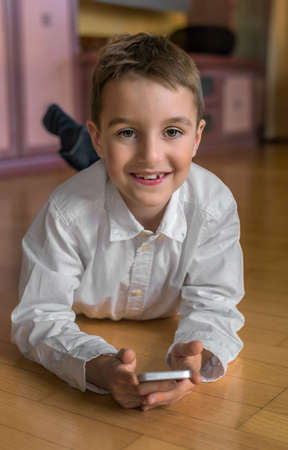 a child playing with a cell phone. mobile phone for kidsの写真素材