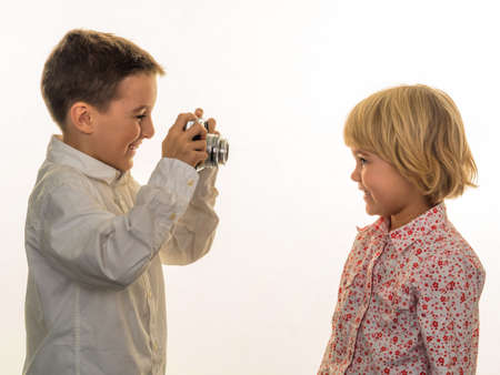 two children photographed with an old camera.の写真素材