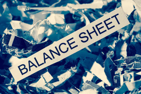 papierschnitzel tagged balance sheet, symbol photo for data destruction, balance sheets and accountingの写真素材