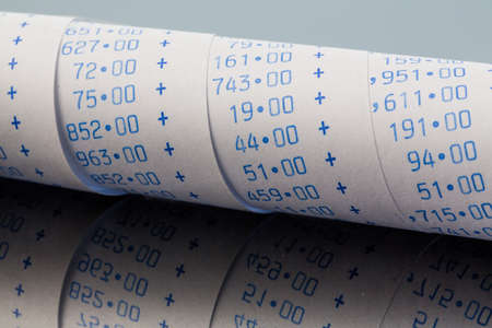 the computing strips of a calculator on a white background. symbol photo for controlling, accounting, taxation and financeの写真素材