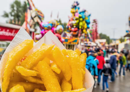 french fries in a bag at a fairgroundの写真素材