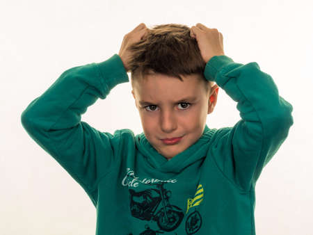 a boy is angry and tearing her hairの写真素材