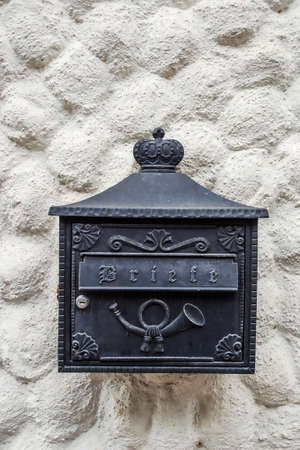 a mailbox on a huasmauer waits for incoming lettersの写真素材