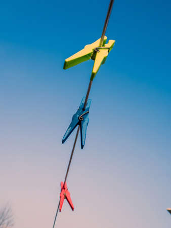 colorful clothespins on a clothes line.の写真素材