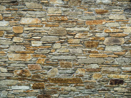 a stone wall protects from view in a garden.
