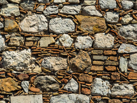 an old stone wall in taormina, sicily, italy.