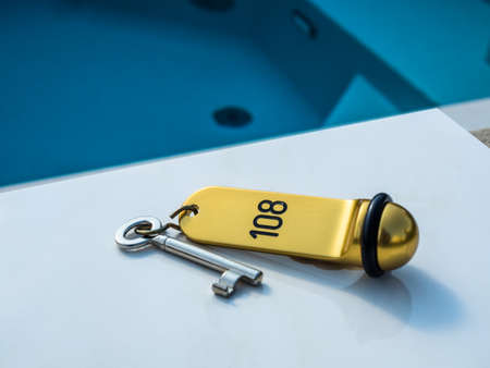 a hotel key on a table next to dempoolの写真素材