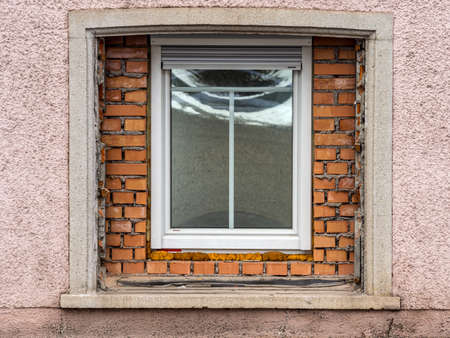 in an old residential building a large window was replaced by a new one. symbol for building renovation and housing improvementの写真素材