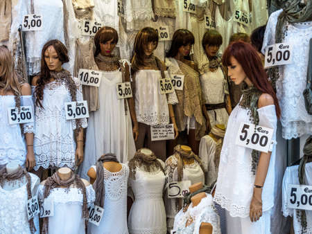 showcase a boutique with white clothesの写真素材