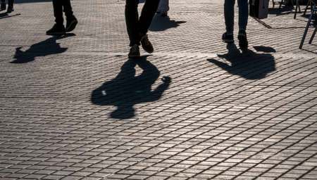 shadows of passersby on the street plasterの写真素材