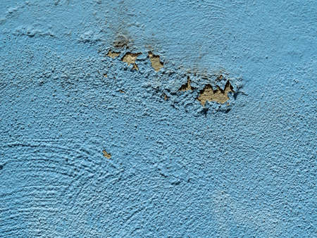 on a blue wall paint peeling off. concept image as background
