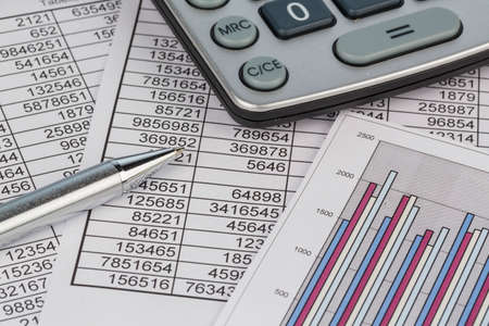 a calculator is located on the numbers a balance us statistics. symbol photo turnover, profits and...