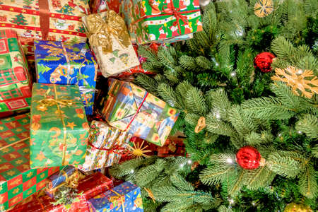 many are wrapped christmas presents on christmas eve under the christmas treeの写真素材