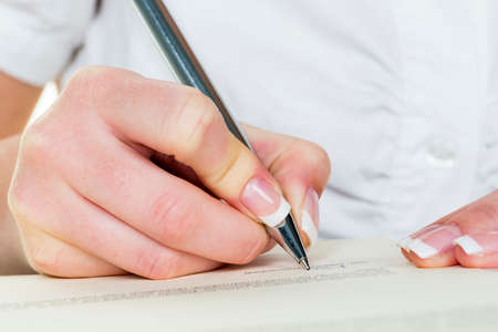 hand with fountain pen signs contractの写真素材