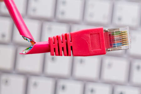 broken network cable on keyboardの写真素材