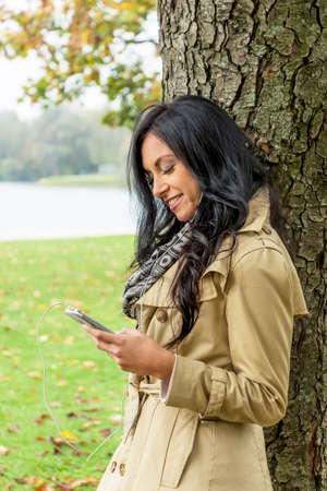 woman listens to music on the mobile phoneの写真素材