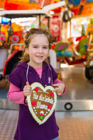 child with gingerbread heartの写真素材