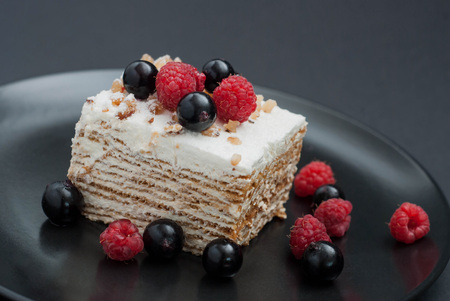 Cheesecake slice with fresh raspberries and mint isolated on whiteの写真素材