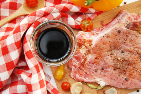 Raw pork steak beef spiced with red tarpaulinの写真素材
