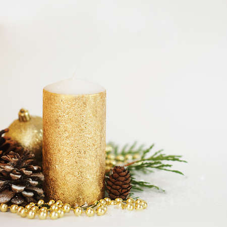Christmas decoration. Golden candle with pinecone and globes.の写真素材