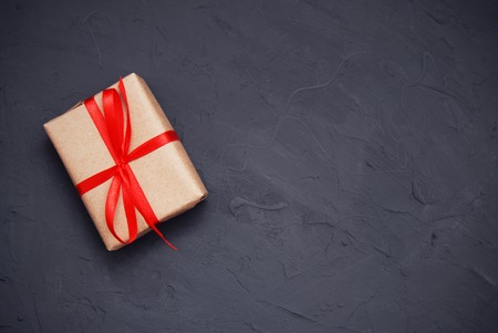 Craft paper wrapped present box craft rope bow ribbon on blue background, top viewの写真素材