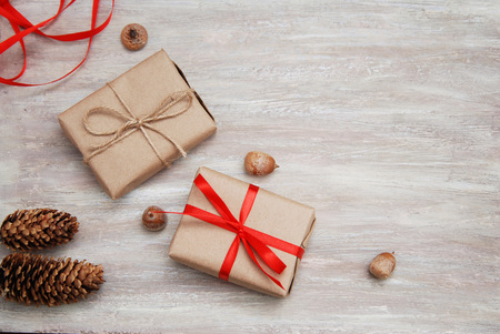 Present box from brown papaer with red ribbon bow on rustic backgroundの写真素材
