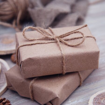 Christmas style rustic brown paper package tied up with stringsの写真素材