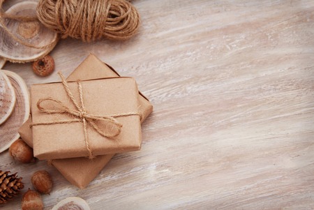 Rustic gift boxes composition with brown paper and wooden accesories. Christmas mood.の写真素材
