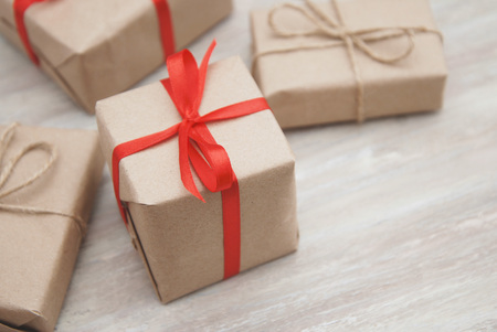 Gift box with Brown rustic paper and red ribbon Bow. Rustic style.の写真素材