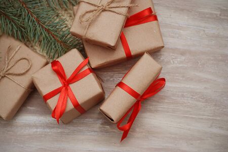 Wrapping eco Christmas packages with brown paper, string and natural fir branchesの写真素材