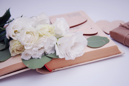 Craft gift box on old shabby wooden table. Still life with lisianthus.の写真素材