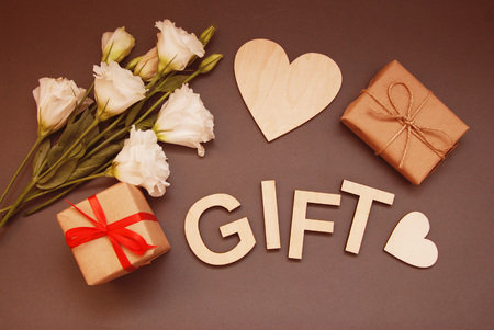 Gift box on the wooden background. Red ribbon. Valentines Day gift.の写真素材