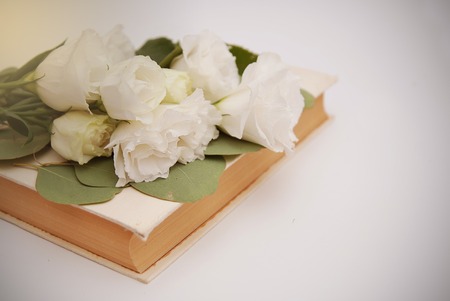 White lisianthus flower bouquet with old bookの写真素材