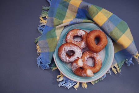 Plate with delicious donut on wooden backgroundの写真素材