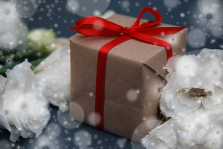 Christmas presents with red ribbon Hand crafted Christmas gift box on blue background with snowflakesの写真素材