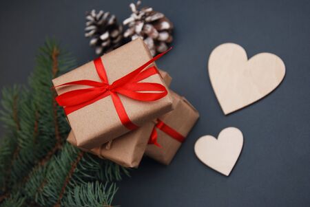 Christmas gift box. Christmas presents in red boxes at black wooden table. Flat lay with copy space.の写真素材