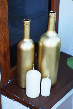 Recycled wine bottles painted in gold for decorationの写真素材
