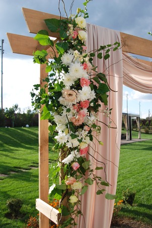 Arch for the wedding ceremony, decorated cloth flowers greenery. Wedding rustic decoration.の写真素材