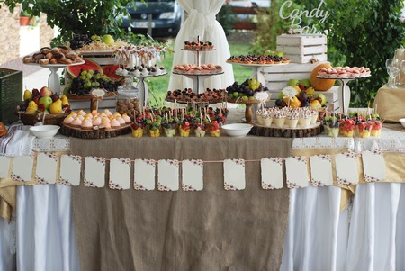 Macaroons, cakes, candies, sweets in a glass dish. Candy bar in wedding.の写真素材