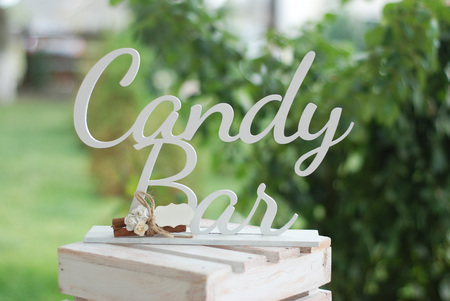 Candy bar inscription with sweets on background.の写真素材