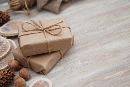 Top view on DIY gift wrapped in craft and decorated with various natural thingsの写真素材