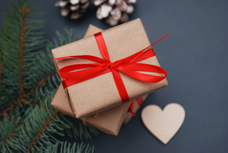 Christmas gift box with red ribbon ondark bluebackground with Fir branches, s. Xmas and Happy New Year composition.の写真素材