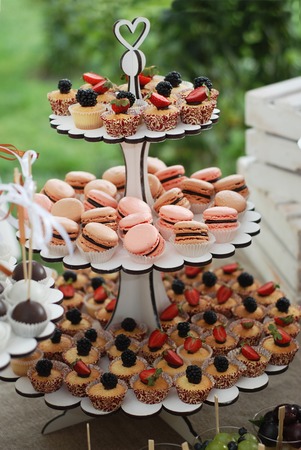 Delicious sweet buffet with cupcakes on shelf. Candy bar.の写真素材