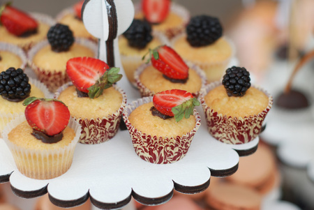 Delicious cupcake with berries and fresh mint on wooden table close upの写真素材