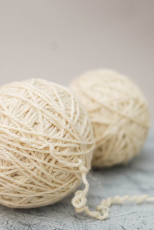 Wool ivory coils for knitting. Winter mood background.の写真素材