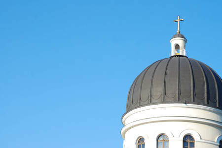 The white church roof has a cross on the sky as the background.の写真素材