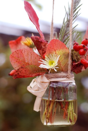 Autumn Flower composition with flowers Chrysanthemum and Maple Leaves in Glass Jarの写真素材