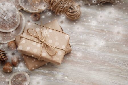 Rustic gift box with orange ribbon bow, on old wood tableの写真素材