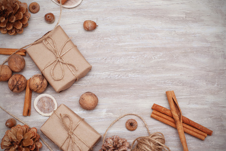 Three Brown Boxes with kraft paper. Christmas Decorated background. Cinnamon Sticks and Pinecone.の写真素材