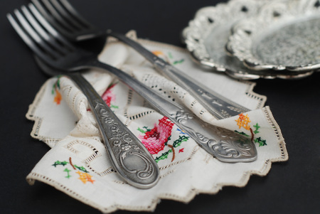 Rustic silver spoons collection on embroidery napkinの写真素材